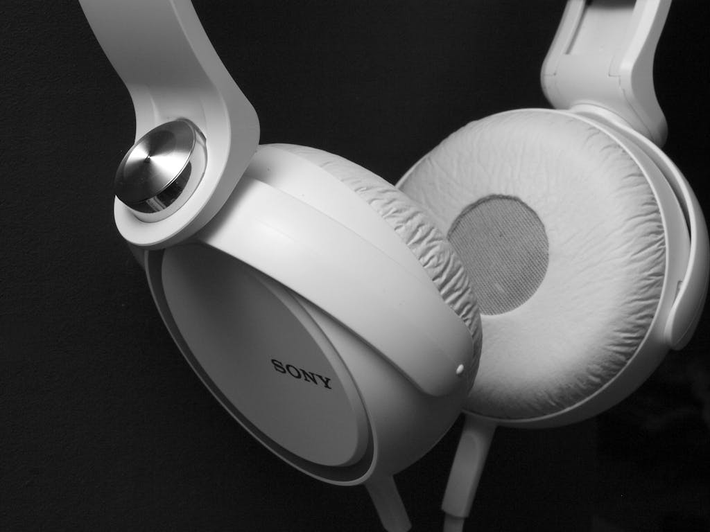 Black and white photo of Sony white headphones close-up.