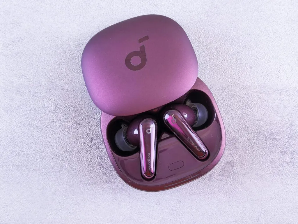 Modern purple earbuds resting in an open case, featuring glossy finish and sleek design.