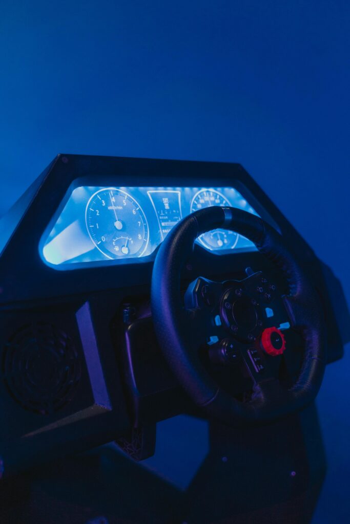 Close-up of a high-tech racing simulator with illuminated dials and steering wheel.