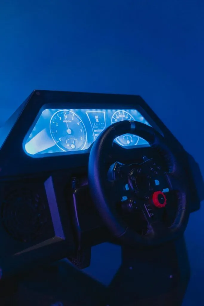 Close-up of a high-tech racing simulator with illuminated dials and steering wheel.