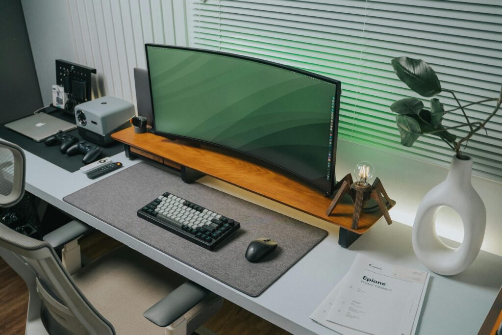A sleek office desk with tech gadgets and decor, perfect for productivity.
